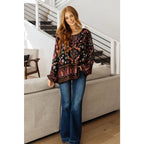 Our I Feel That Peasant Blouse is beautifully textured with a lightweight woven black fabric features tie-neck keyhole