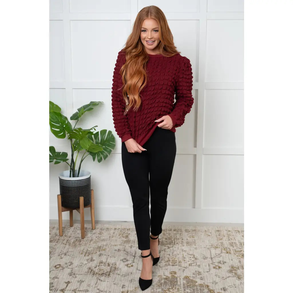 Our In Denial Bubble Pullover Top in Maroon will elevate any wardrobe! Showcase your trendy style with the shoulder