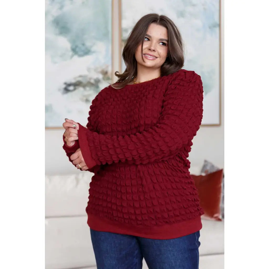 Our In Denial Bubble Pullover Top in Maroon will elevate any wardrobe! Showcase your trendy style with the shoulder