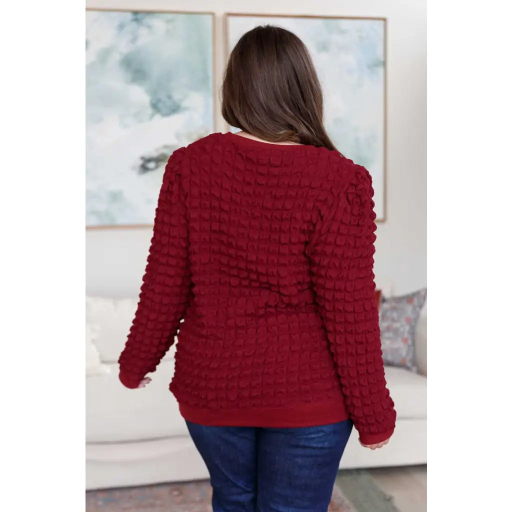 Our In Denial Bubble Pullover Top in Maroon will elevate any wardrobe! Showcase your trendy style with the shoulder
