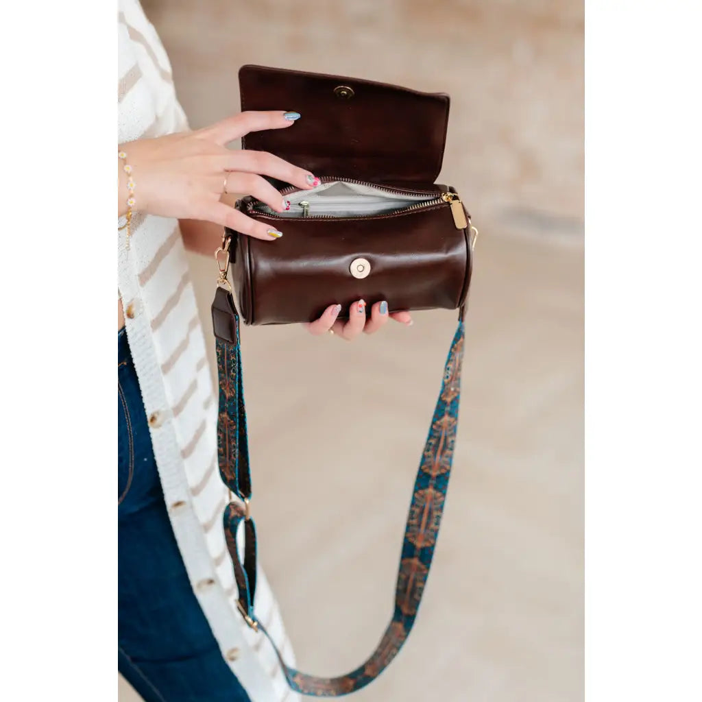 Our In the Barrel Crossbody Bag is perfect accessory! Made with faux leather and gold toned hardware its gorgeous