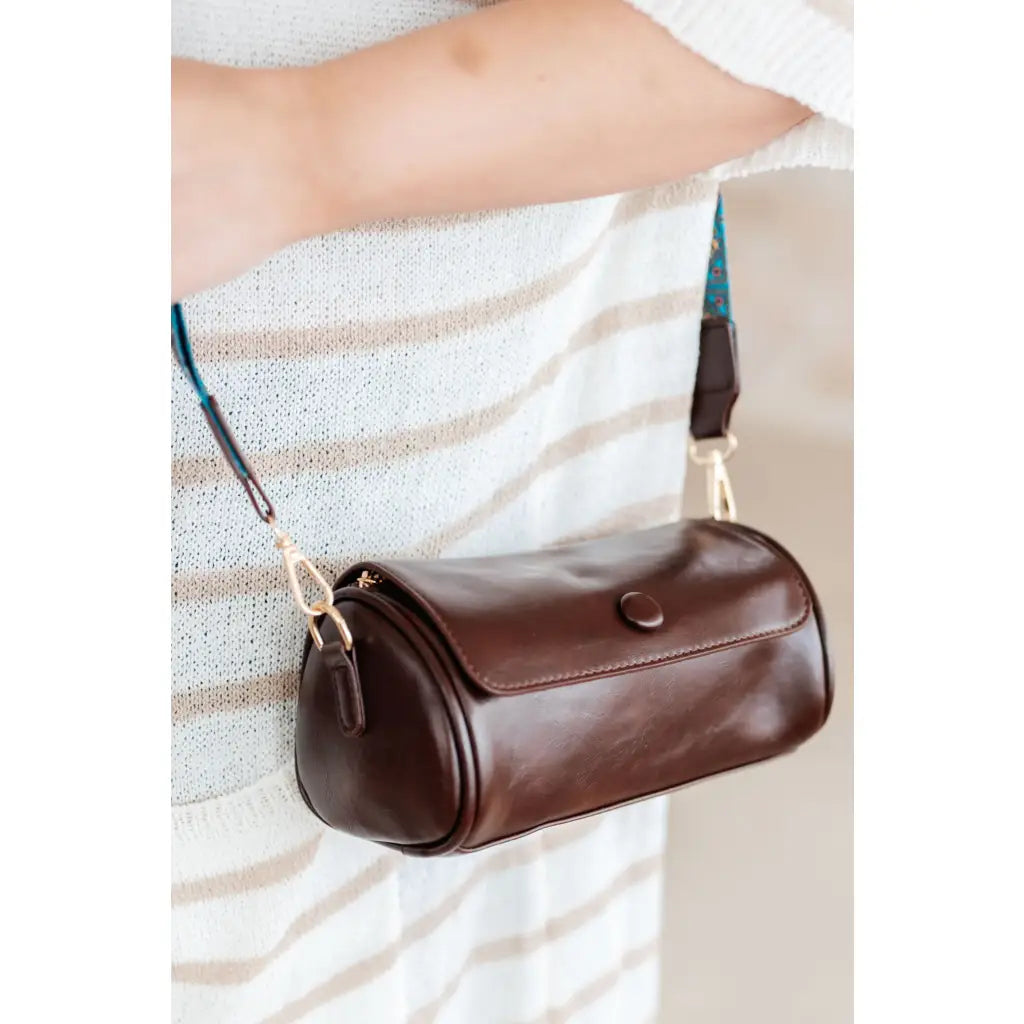 Our In the Barrel Crossbody Bag is perfect accessory! Made with faux leather and gold toned hardware its gorgeous