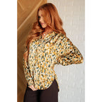 Our In the Willows Button Up Blouse is made with luxurious poly satin in an abstract mix of mustard beige and forest
