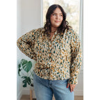 Our In the Willows Button Up Blouse is made with luxurious poly satin in an abstract mix of mustard beige and forest