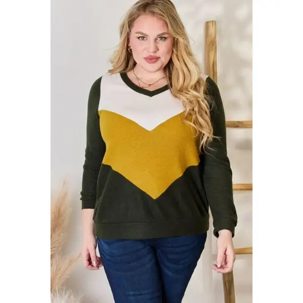 Our Invested Color Block V-Neck Top is stylish and contemporary! Featuring trendy contrasting blocks of color long