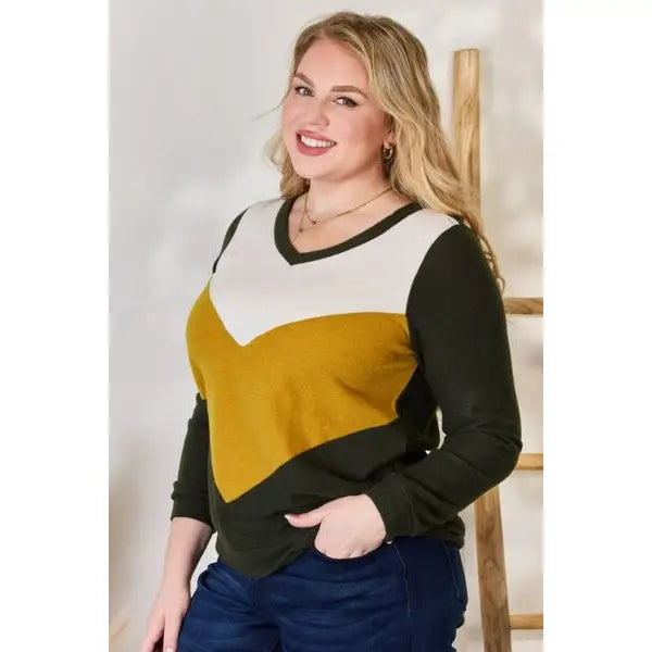 Our Invested Color Block V-Neck Top is stylish and contemporary! Featuring trendy contrasting blocks of color long