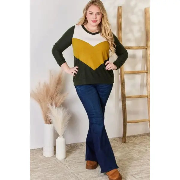 Our Invested Color Block V-Neck Top is stylish and contemporary! Featuring trendy contrasting blocks of color long