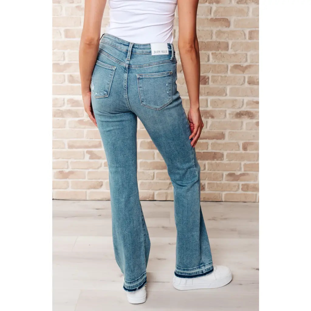 Our Isla Mid Rise Distressed Released Hem Bootcut Judy Blue Jeans! are the ultimate in comfort Figure flattering