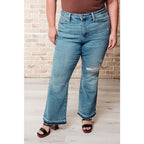 Our Isla Mid Rise Distressed Released Hem Bootcut Judy Blue Jeans! are the ultimate in comfort Figure flattering