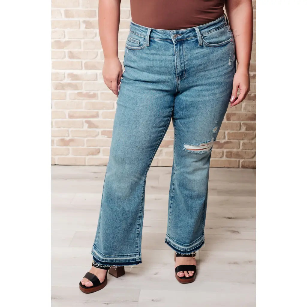 Our Isla Mid Rise Distressed Released Hem Bootcut Judy Blue Jeans! are the ultimate in comfort Figure flattering
