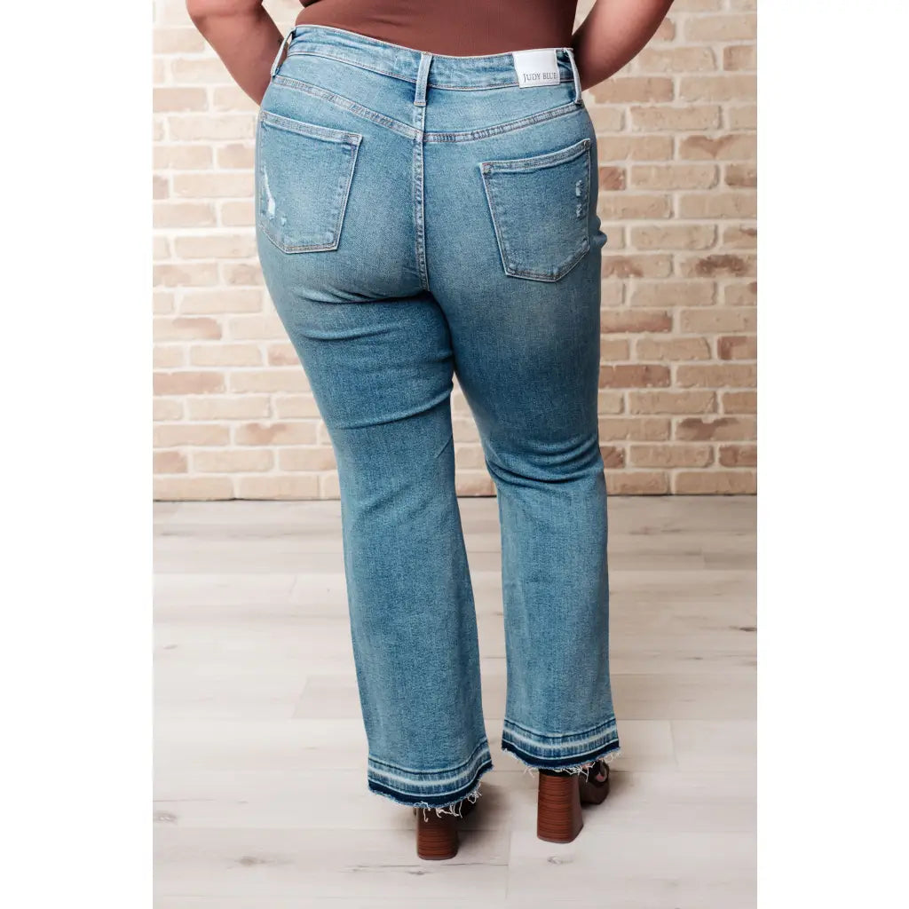 Our Isla Mid Rise Distressed Released Hem Bootcut Judy Blue Jeans! are the ultimate in comfort Figure flattering