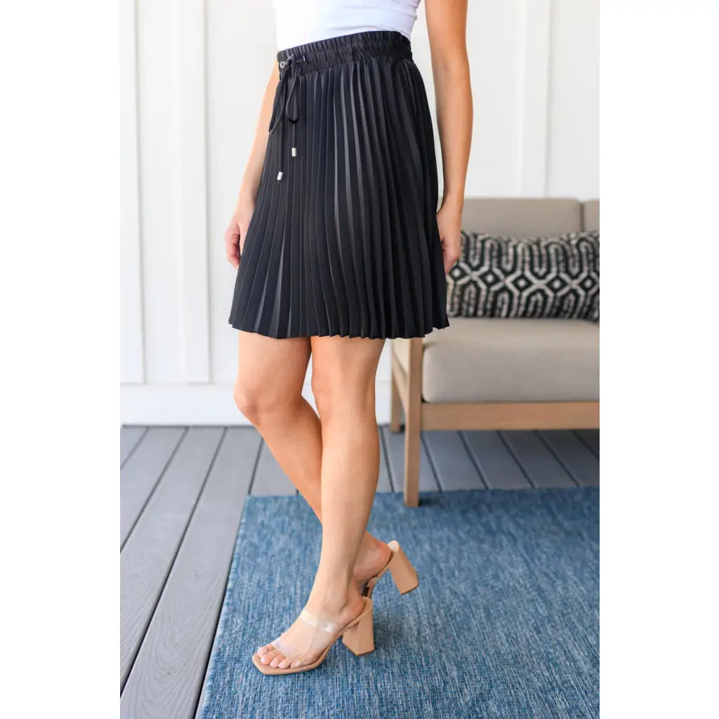 This gorgeous skirt is crafted from a black poly satin with an ultra-luxe feel. knee length high-waisted accordion