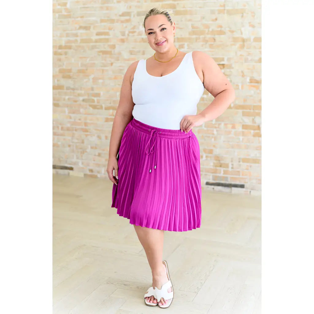 This gorgeous skirt is crafted from a magenta poly satin with an ultra-luxe feel. knee length high-waisted accordion