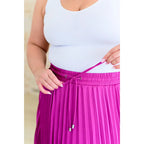 This gorgeous skirt is crafted from a magenta poly satin with an ultra-luxe feel. knee length high-waisted accordion