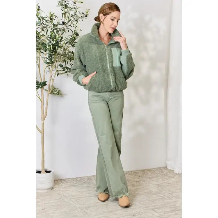 This cozy and chic jacket is a must-have for the colder months featuring soft luxurious sage sherpa fabric