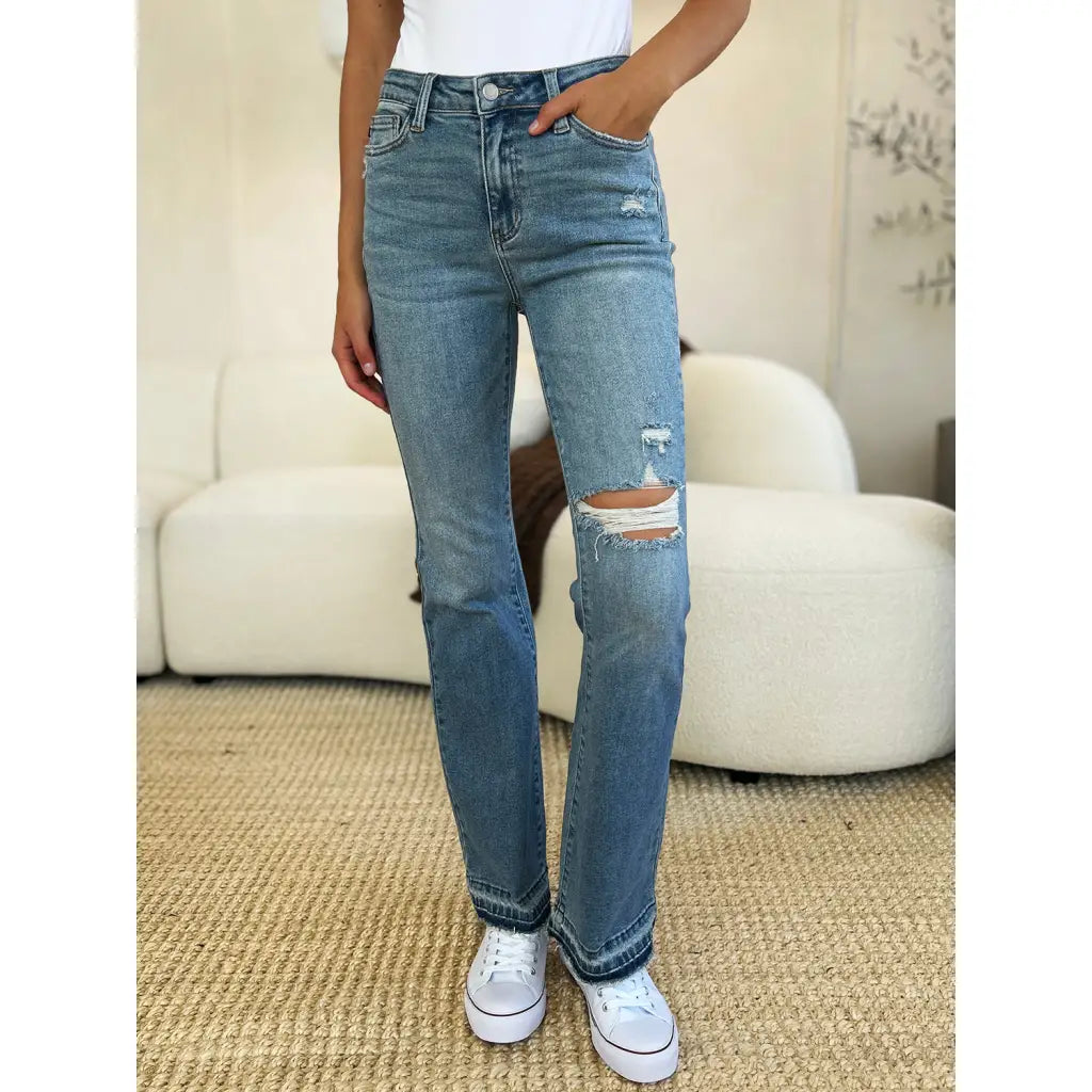 Our Laid Back Mid Rise Destroyed Hem Judy Blue Jeans are a trendy and edgy addition to your distressed denim