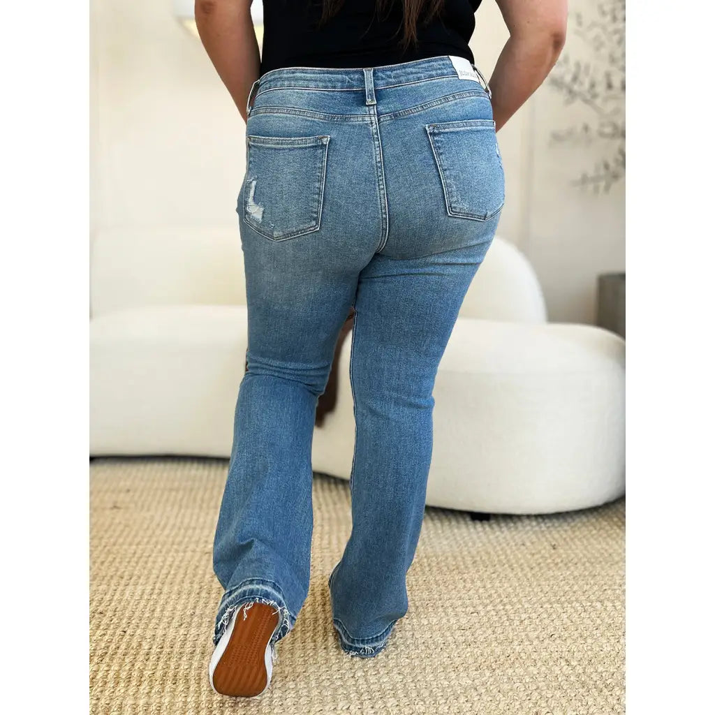 Our Laid Back Mid Rise Destroyed Hem Judy Blue Jeans are a trendy and edgy addition to your distressed denim