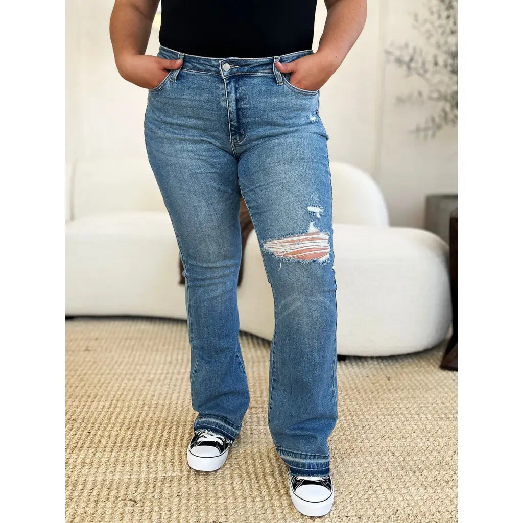 Our Laid Back Mid Rise Destroyed Hem Judy Blue Jeans are a trendy and edgy addition to your distressed denim