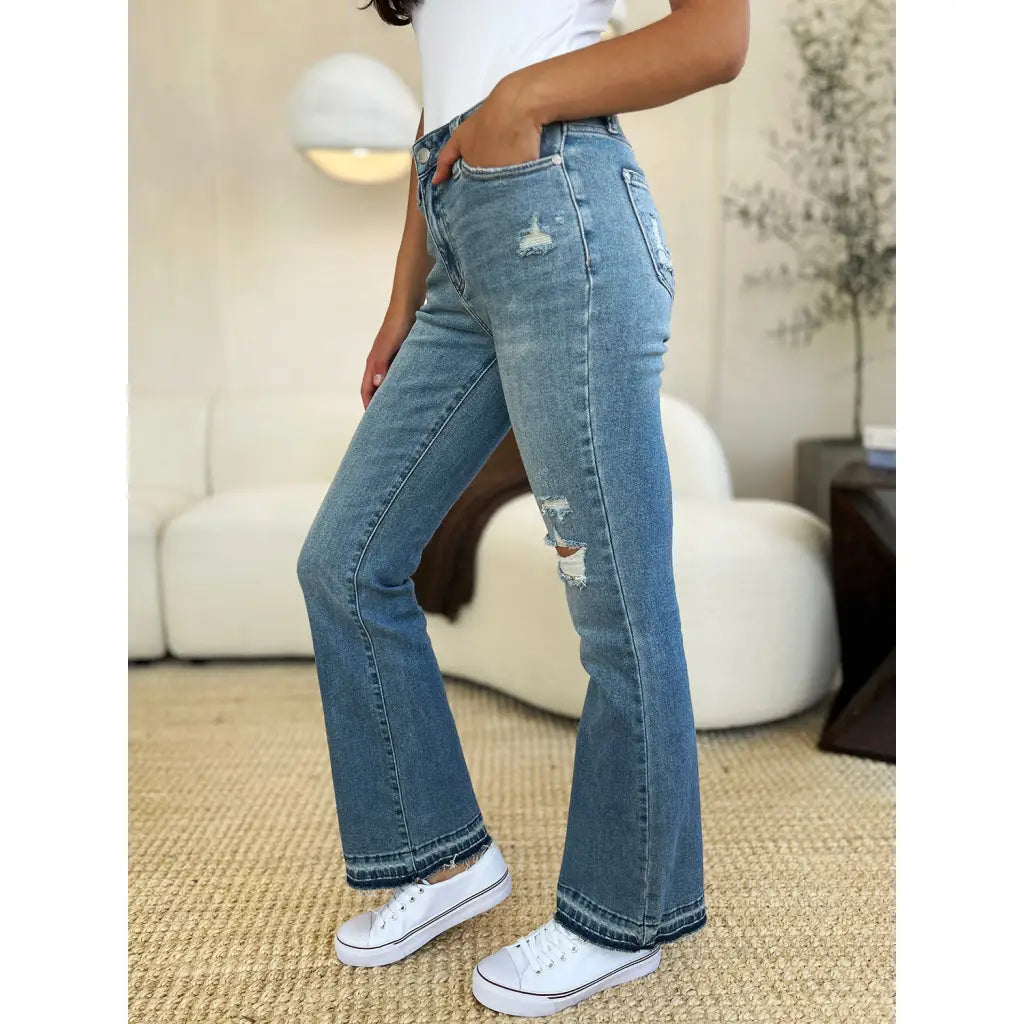 Our Laid Back Mid Rise Destroyed Hem Judy Blue Jeans are a trendy and edgy addition to your distressed denim