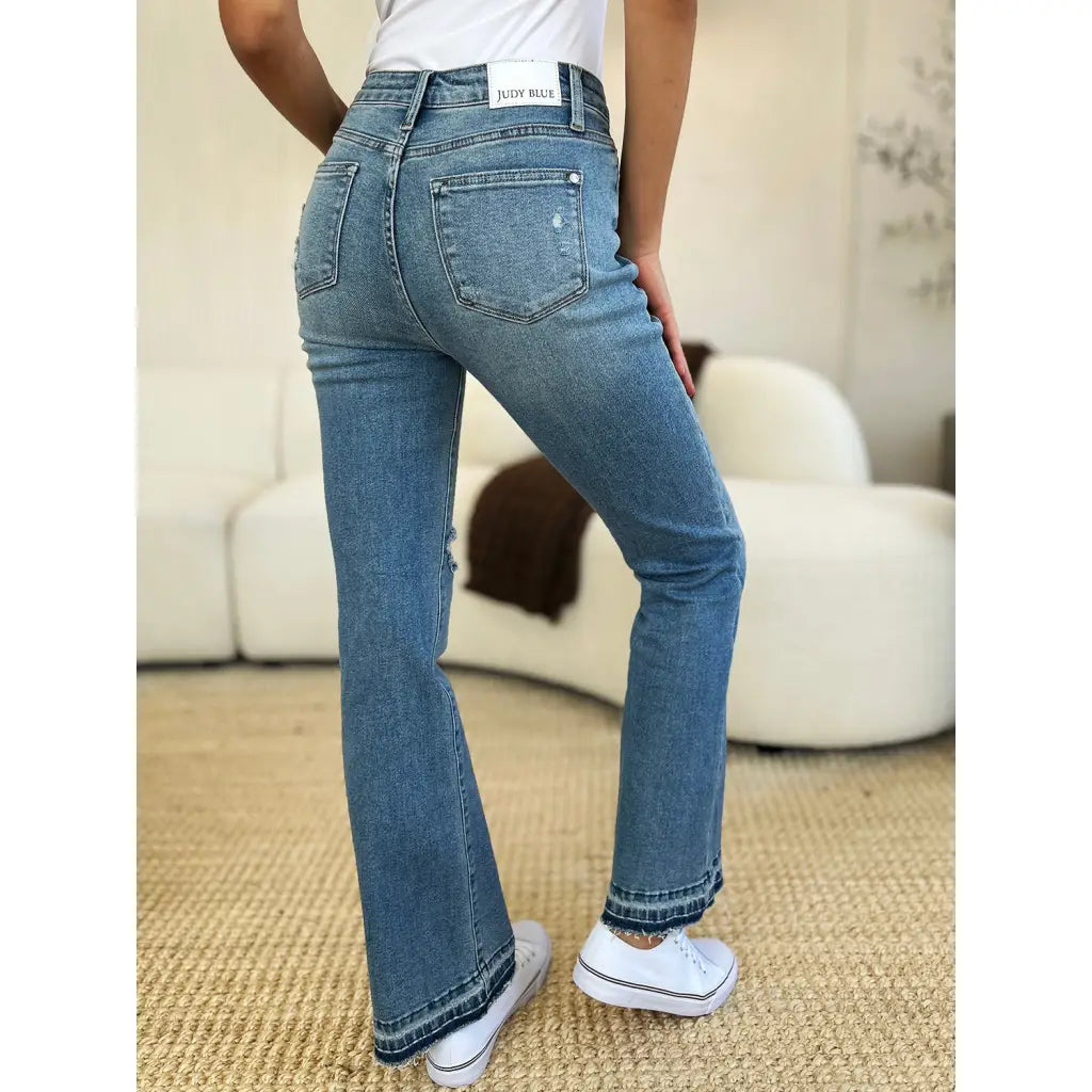 Our Laid Back Mid Rise Destroyed Hem Judy Blue Jeans are a trendy and edgy addition to your distressed denim