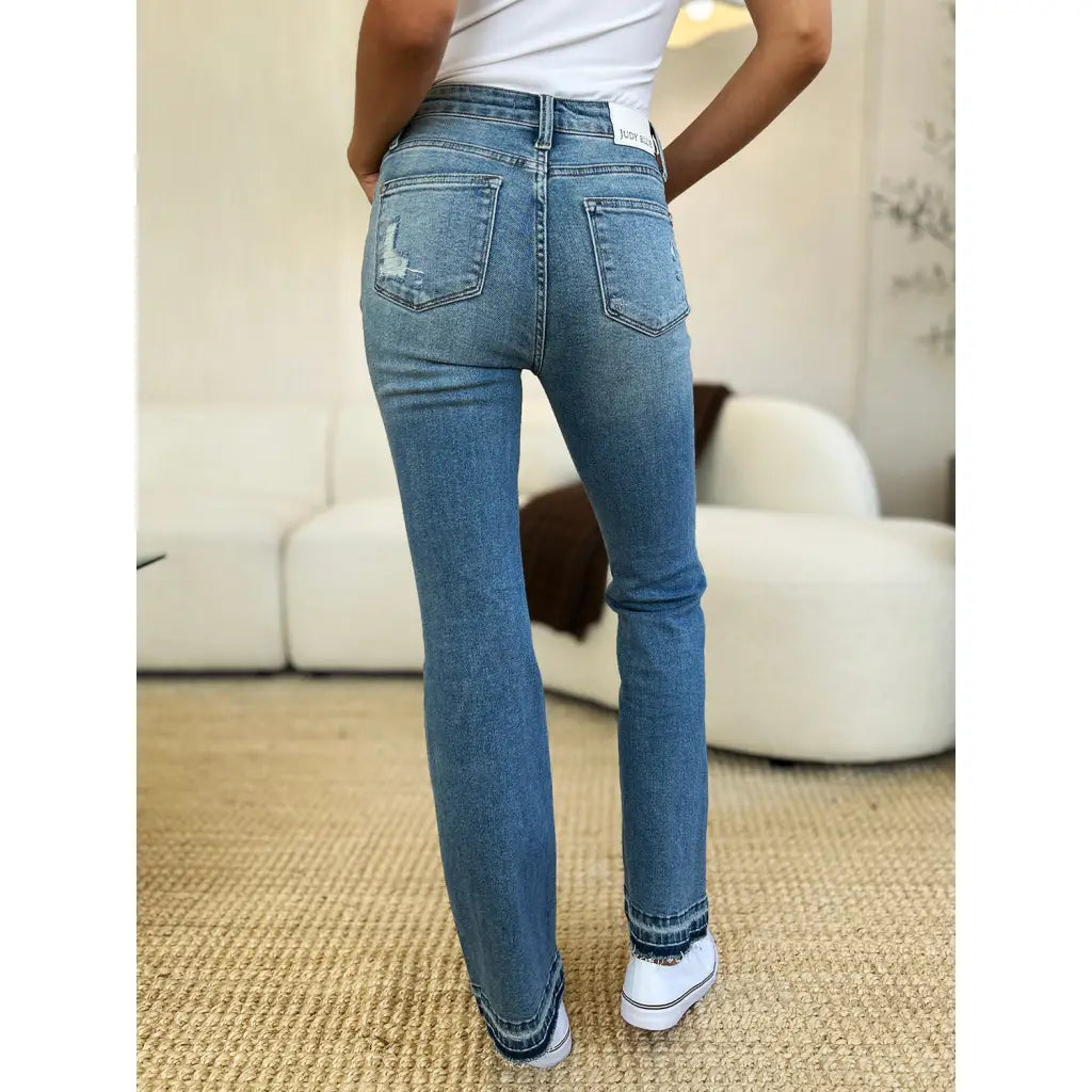Our Laid Back Mid Rise Destroyed Hem Judy Blue Jeans are a trendy and edgy addition to your distressed denim