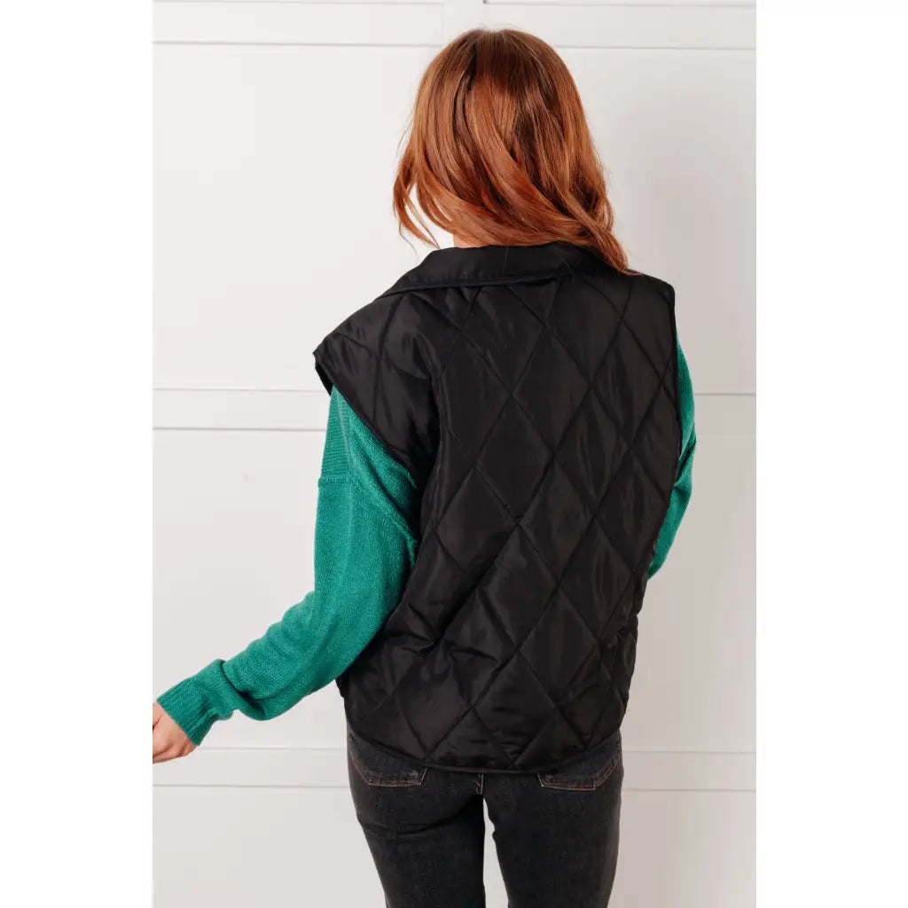 Our Layering Queen Puffer Vest is made from a black quilted windbreaker material. This vest will keep you warm