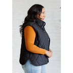 Our Layering Queen Puffer Vest is made from a black quilted windbreaker material. This vest will keep you warm
