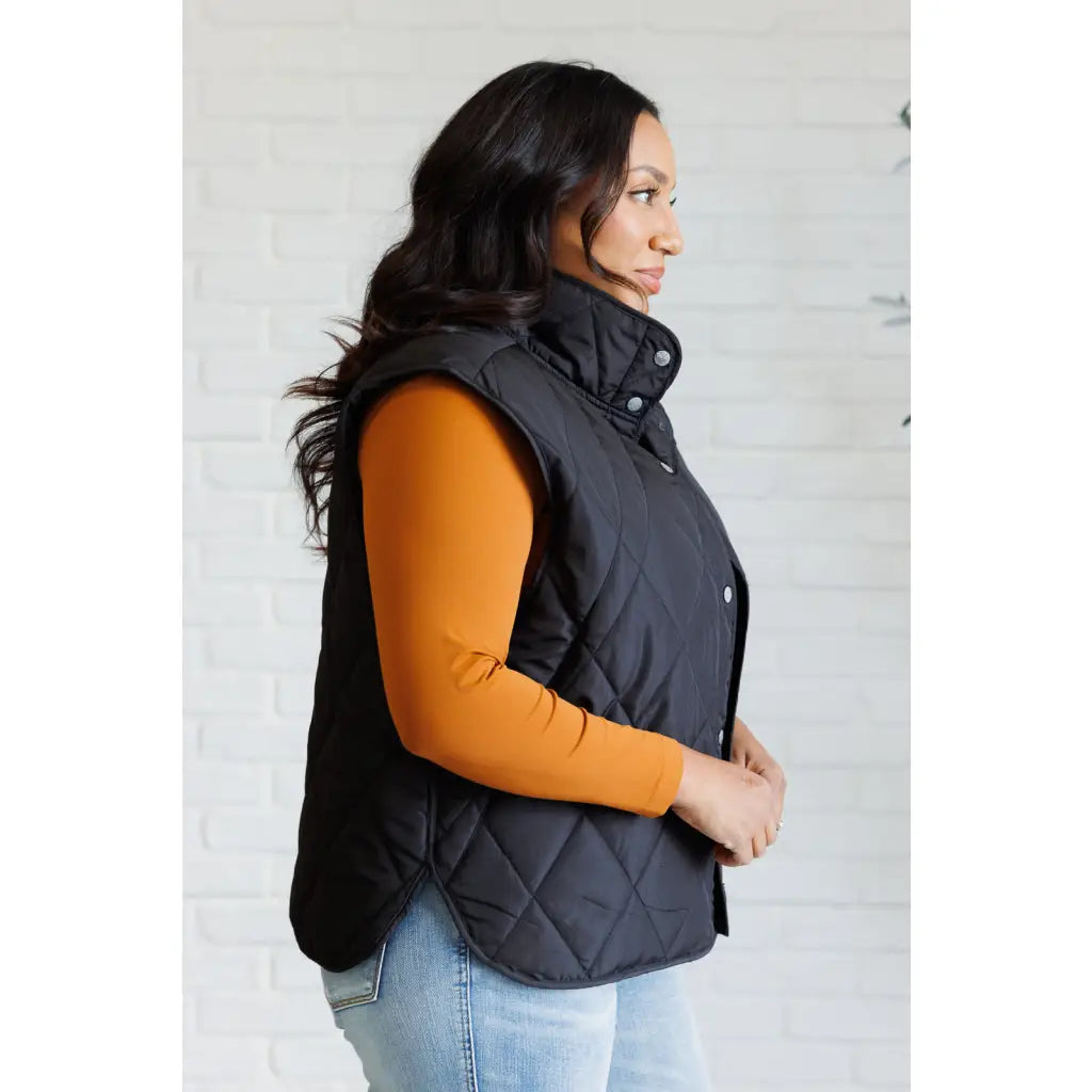 Our Layering Queen Puffer Vest is made from a black quilted windbreaker material. This vest will keep you warm