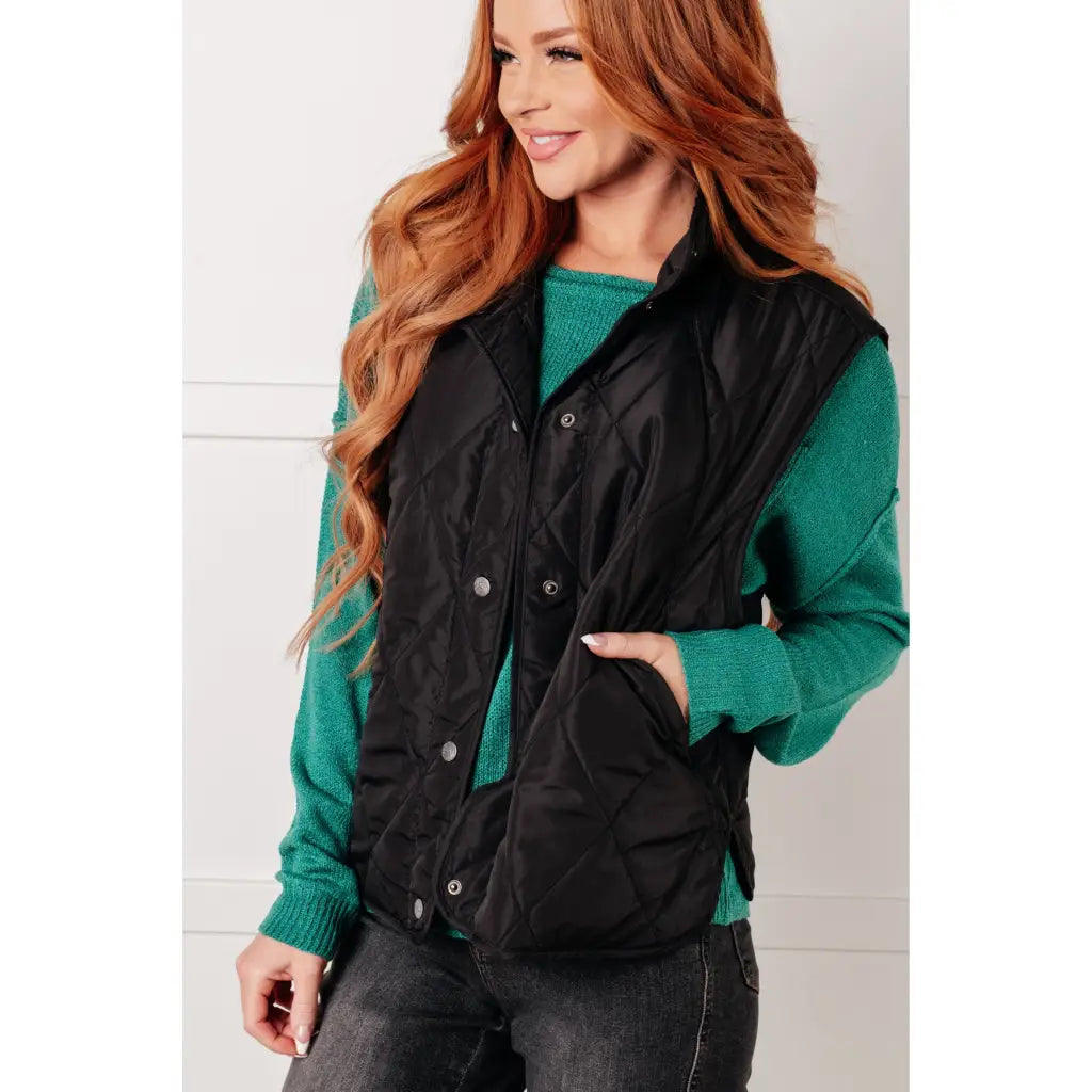 Our Layering Queen Puffer Vest is made from a black quilted windbreaker material. This vest will keep you warm