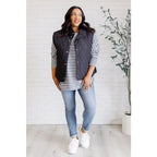 Our Layering Queen Puffer Vest is made from a black quilted windbreaker material. This vest will keep you warm