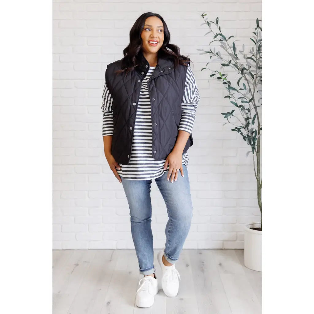 Our Layering Queen Puffer Vest is made from a black quilted windbreaker material. This vest will keep you warm