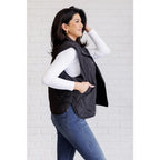 Our Layering Queen Puffer Vest is made from a black quilted windbreaker material. This vest will keep you warm