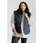 Our Layering Queen Puffer Vest is made from a black quilted windbreaker material. This vest will keep you warm