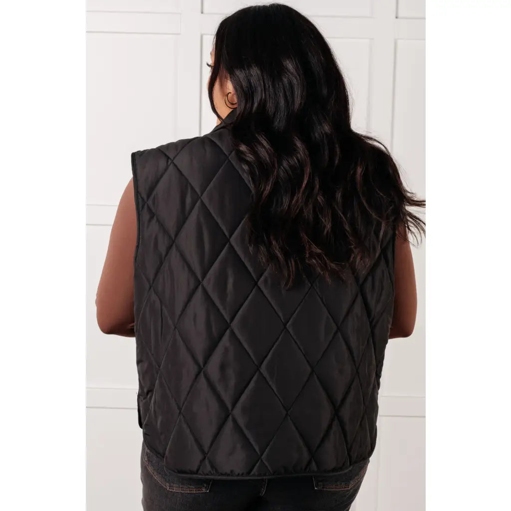 Our Layering Queen Puffer Vest is made from a black quilted windbreaker material. This vest will keep you warm