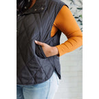 Our Layering Queen Puffer Vest is made from a black quilted windbreaker material. This vest will keep you warm