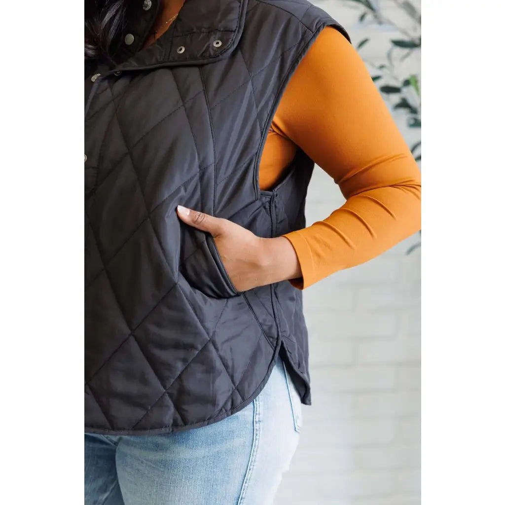 Our Layering Queen Puffer Vest is made from a black quilted windbreaker material. This vest will keep you warm