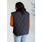 Our Layering Queen Puffer Vest is made from a black quilted windbreaker material. This vest will keep you warm