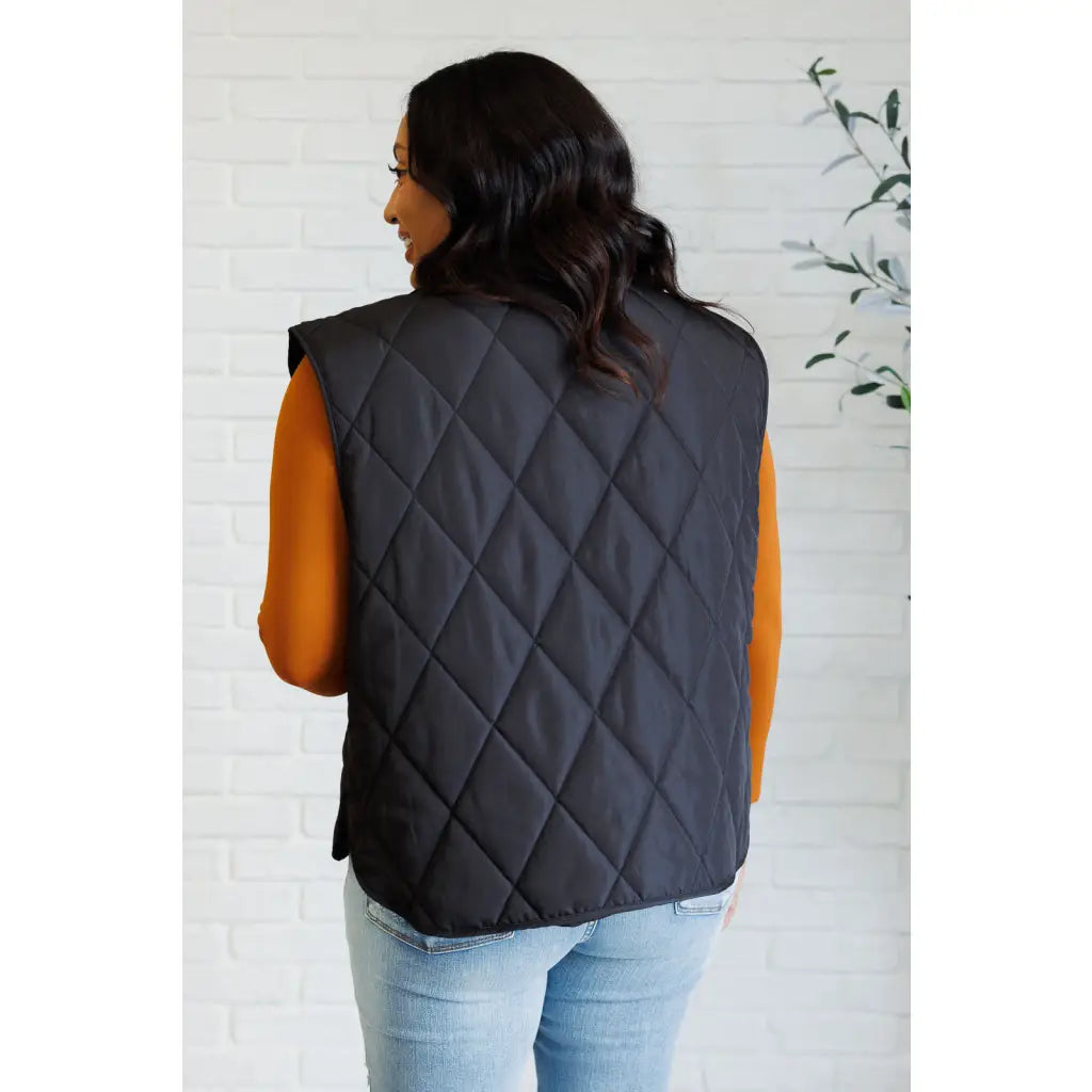 Our Layering Queen Puffer Vest is made from a black quilted windbreaker material. This vest will keep you warm
