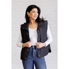 Our Layering Queen Puffer Vest is made from a black quilted windbreaker material. This vest will keep you warm