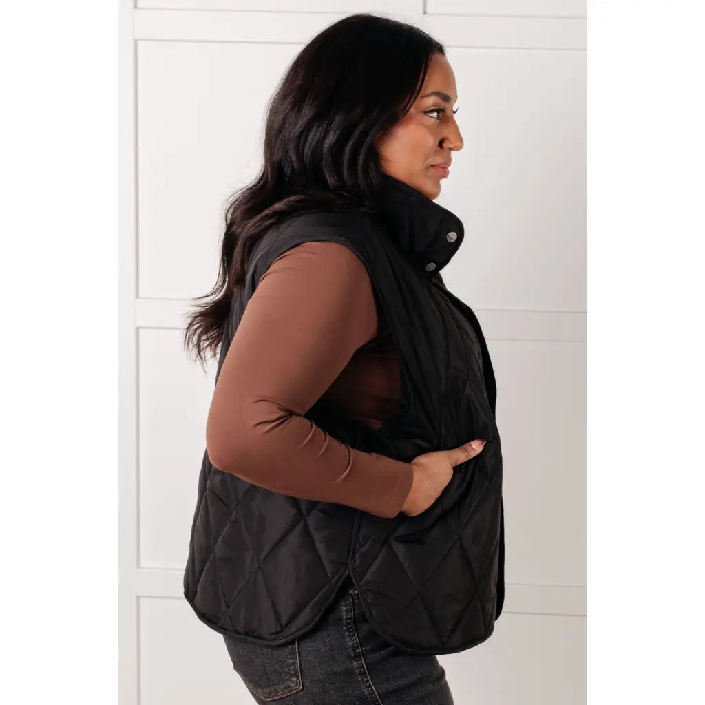 Our Layering Queen Puffer Vest is made from a black quilted windbreaker material. This vest will keep you warm