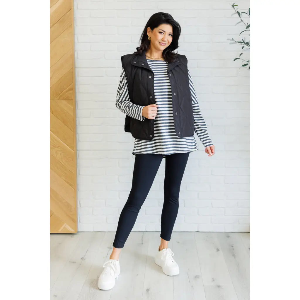 Our Layering Queen Puffer Vest is made from a black quilted windbreaker material. This vest will keep you warm