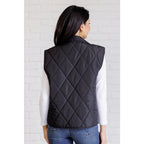 Our Layering Queen Puffer Vest is made from a black quilted windbreaker material. This vest will keep you warm
