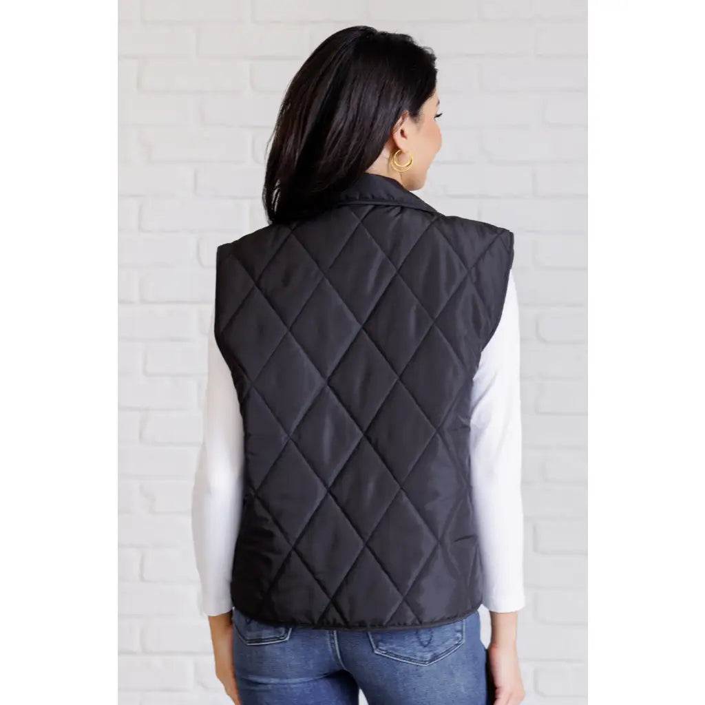 Our Layering Queen Puffer Vest is made from a black quilted windbreaker material. This vest will keep you warm