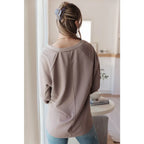 Stay effortlessly stylish with the Less Conversation V-Neck Top in beige. Featuring a textured knit and notched v-neck.