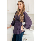 Switch up your wardrobe with this Love On The Line Purple Peplum Blouse! Made from a slinky knit beautiful purple