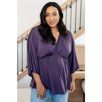 Switch up your wardrobe with this Love On The Line Purple Peplum Blouse! Made from a slinky knit beautiful purple