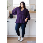 Switch up your wardrobe with this Love On The Line Purple Peplum Blouse! Made from a slinky knit beautiful purple