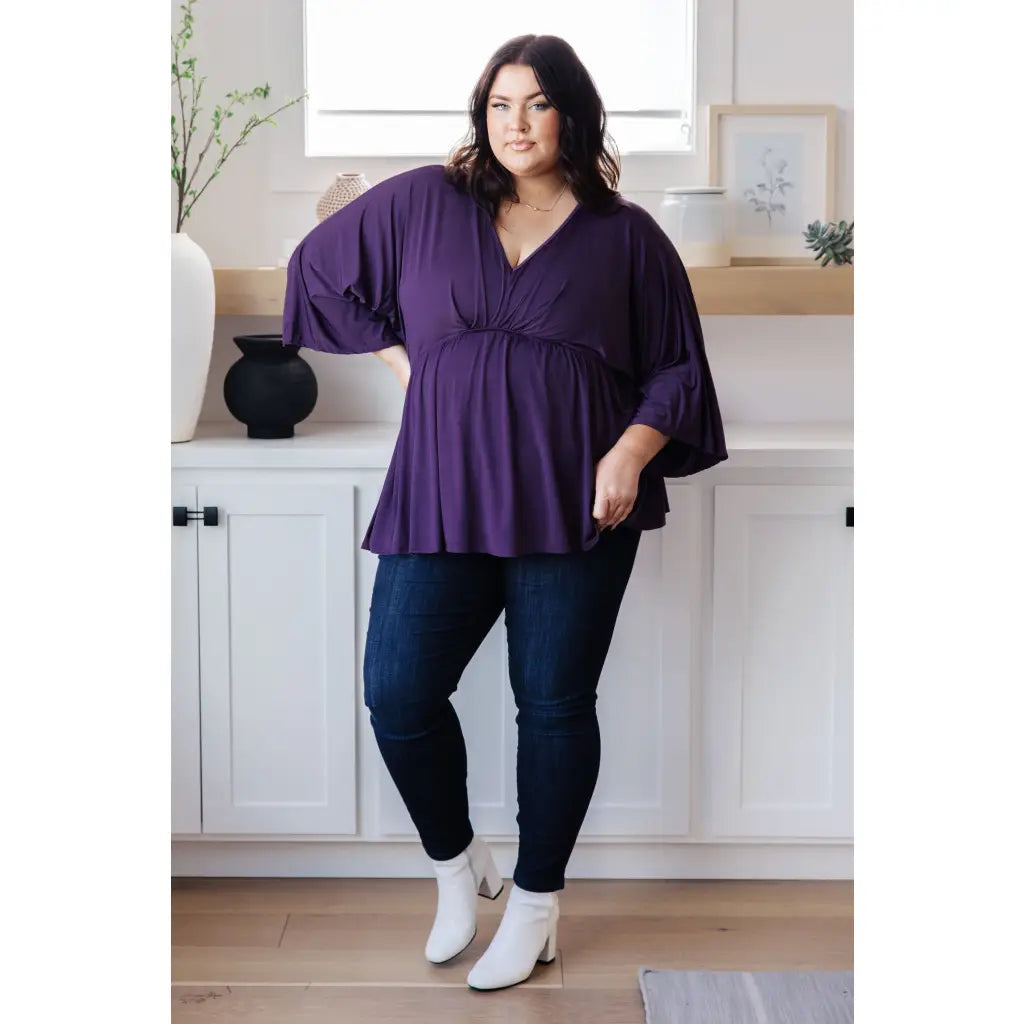 Switch up your wardrobe with this Love On The Line Purple Peplum Blouse! Made from a slinky knit beautiful purple