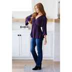 Switch up your wardrobe with this Love On The Line Purple Peplum Blouse! Made from a slinky knit beautiful purple