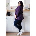 Switch up your wardrobe with this Love On The Line Purple Peplum Blouse! Made from a slinky knit beautiful purple